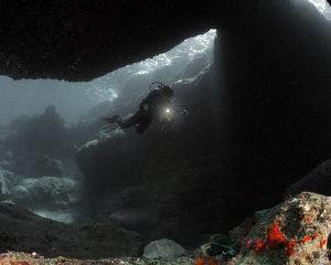 Different saturation levels of this diver inside a cave. by Juan Torres 